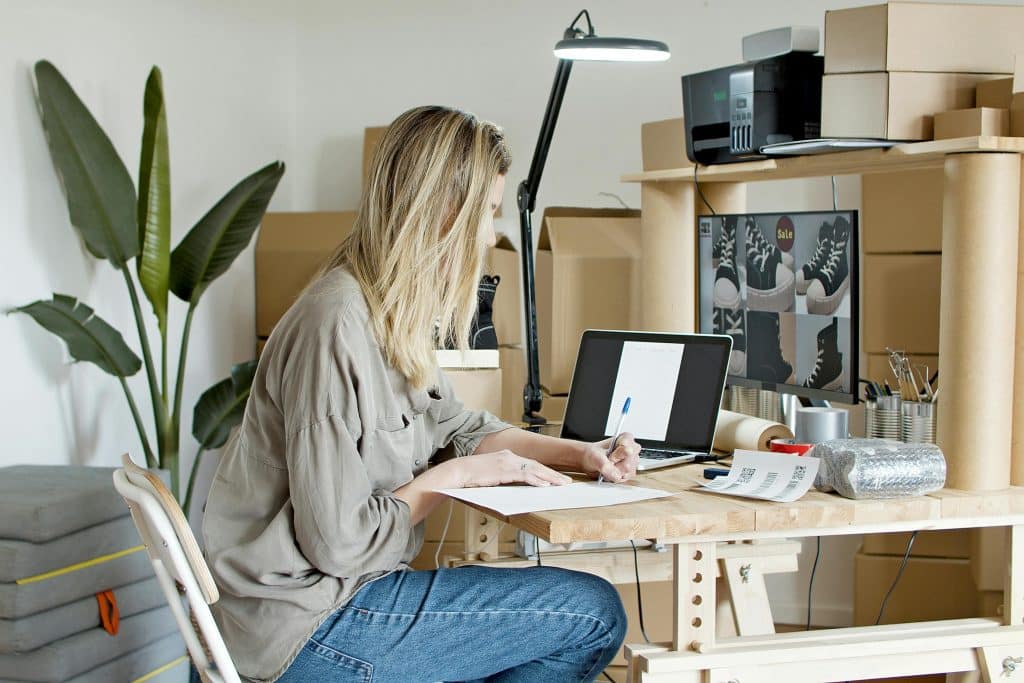 Investing In Yourself - Woman busy working at her desk
