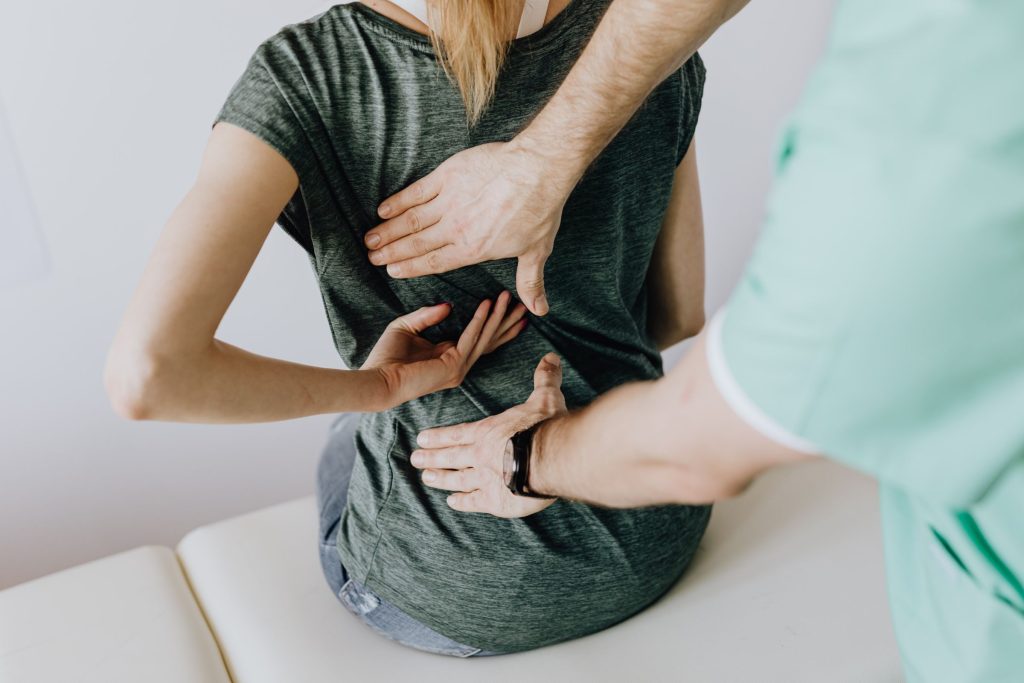 Chronic back pain - doctor working on a person's back