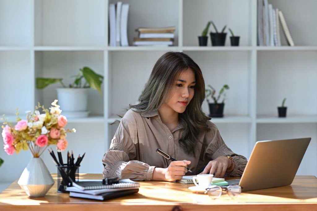 Woman working at desk building a strong business.