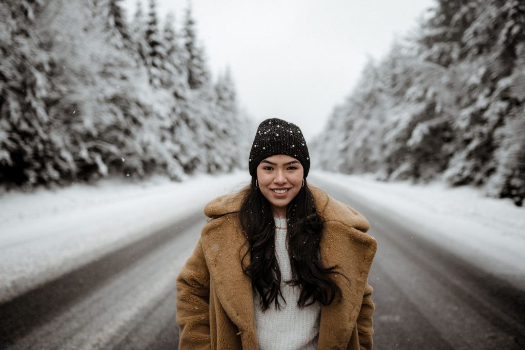 Woman in the middle of a snowy street during the the winter season
