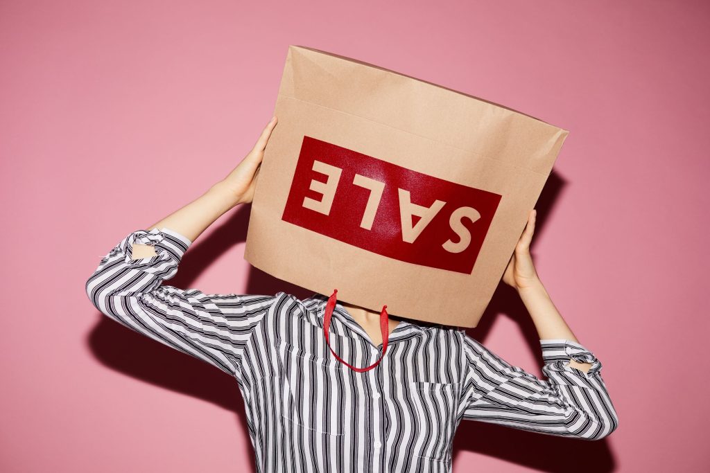 Lifestyle-Enhancement Products on Sale - Person with a sale shopping bag over their head