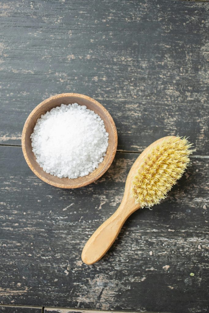 Bowl of sea salt with a brush next to it - enhance your recipes.