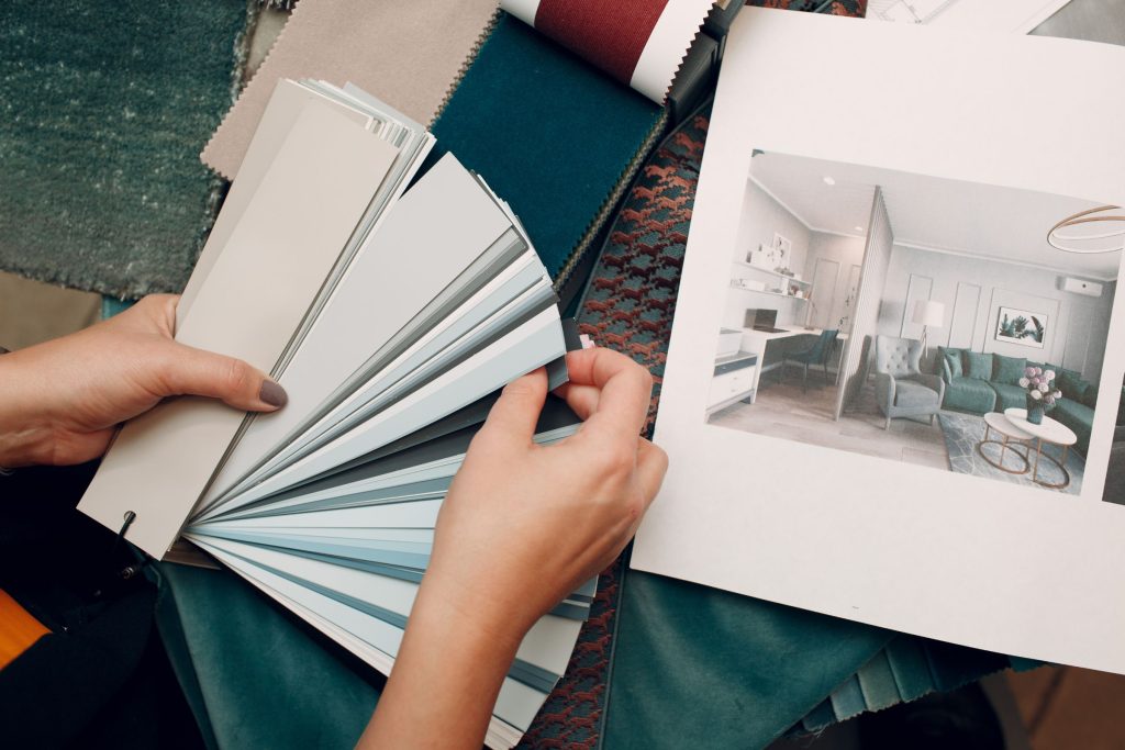 Interior designer with paint colors and fabrics laid out